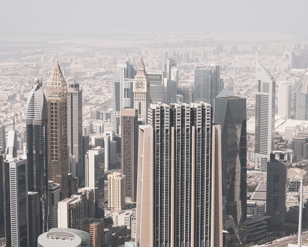 Modern skyscrapers dominate a hazy cityscape background.