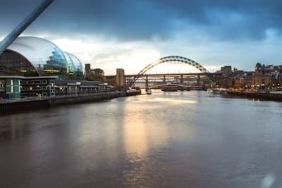 a large bridge over a river next to a tall building