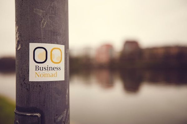 a sticker on a pole near a body of water