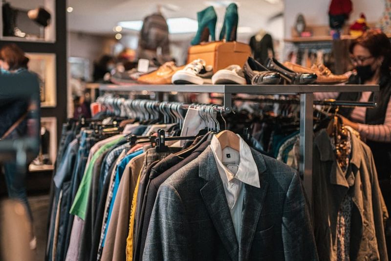 A clothing rail in a fashion store with closing down sale signs