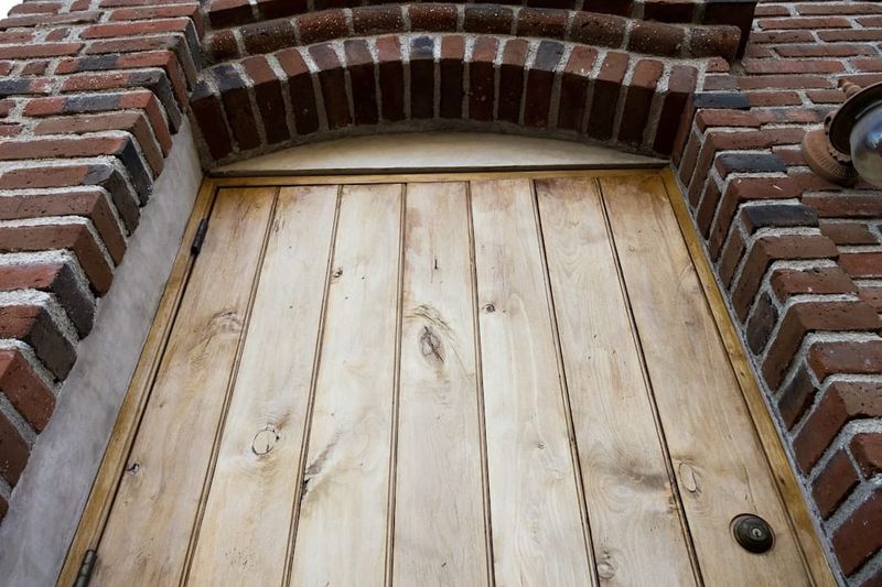 A traditional English pub exterior with wooden door and sign