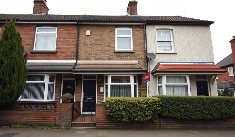 UK terraced houses with a for-sale sign on a grey day.