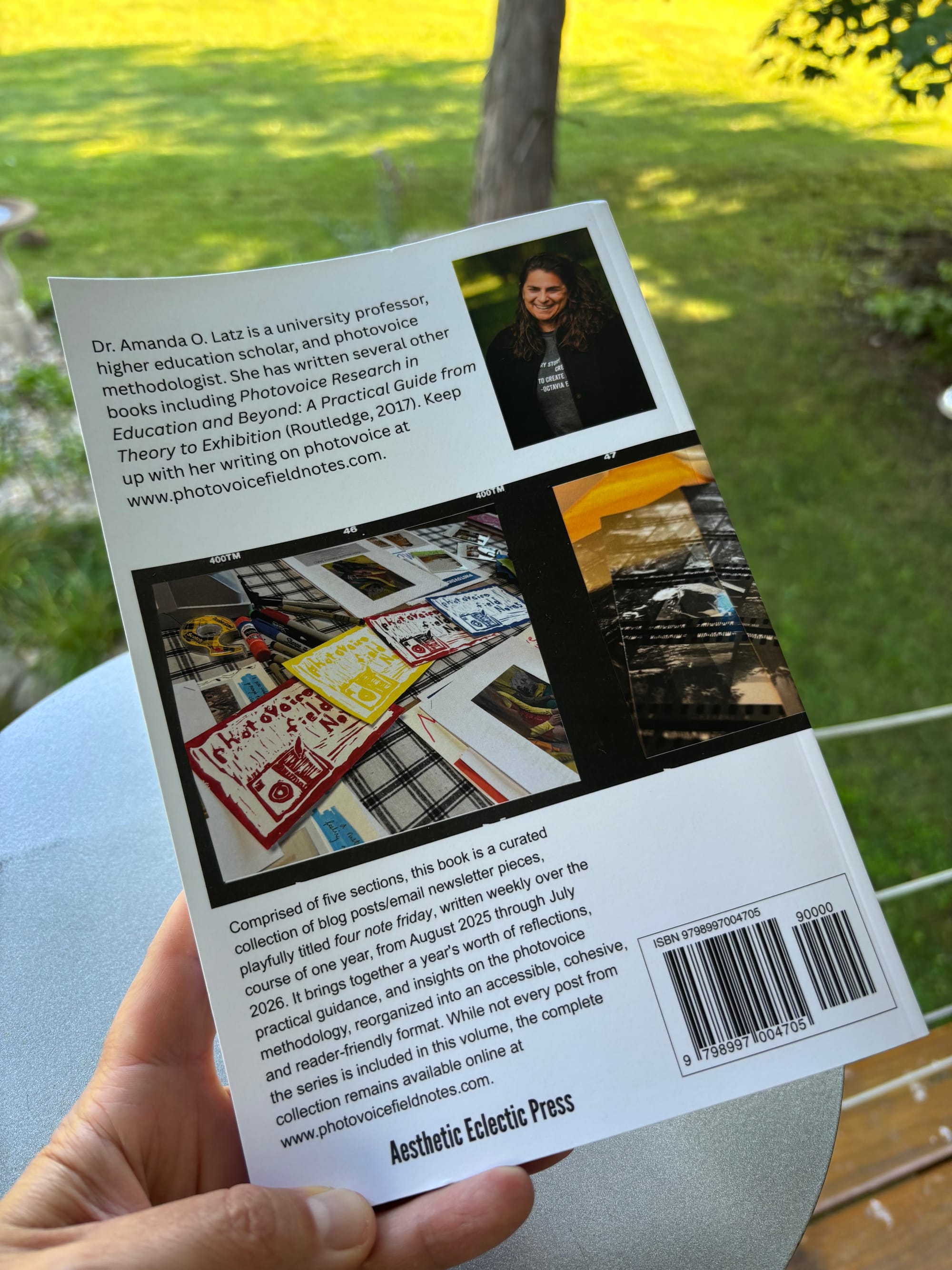 back cover of the book Photovoice Field Notes: Volume One by Amanda O. Latz against a natural background