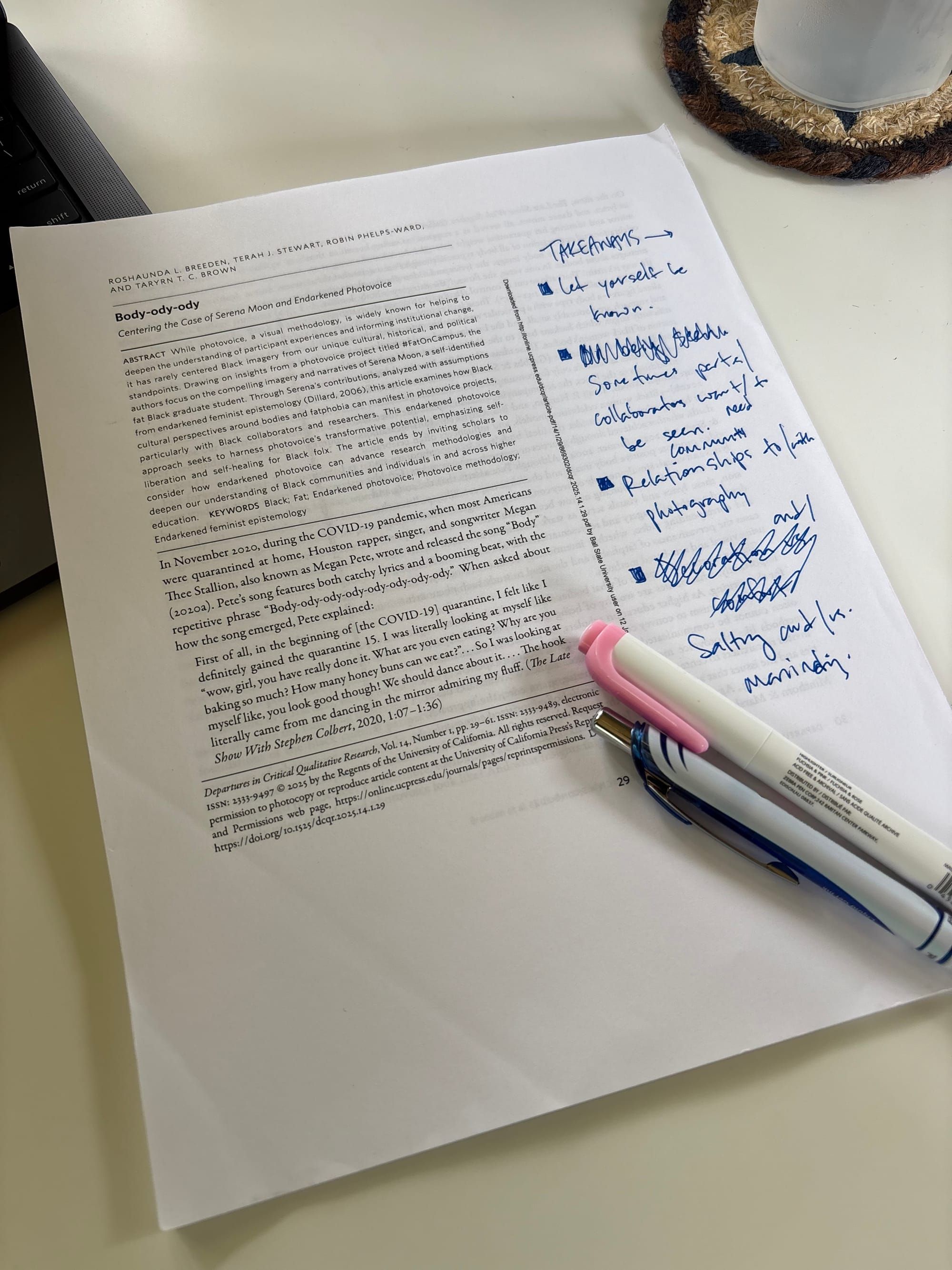 cover page of the article featured in the post with marginalia and a highlighter and pen sitting on top of the paper