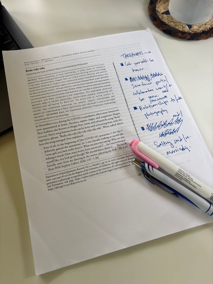 cover page of the article featured in the post with marginalia and a highlighter and pen sitting on top of the paper