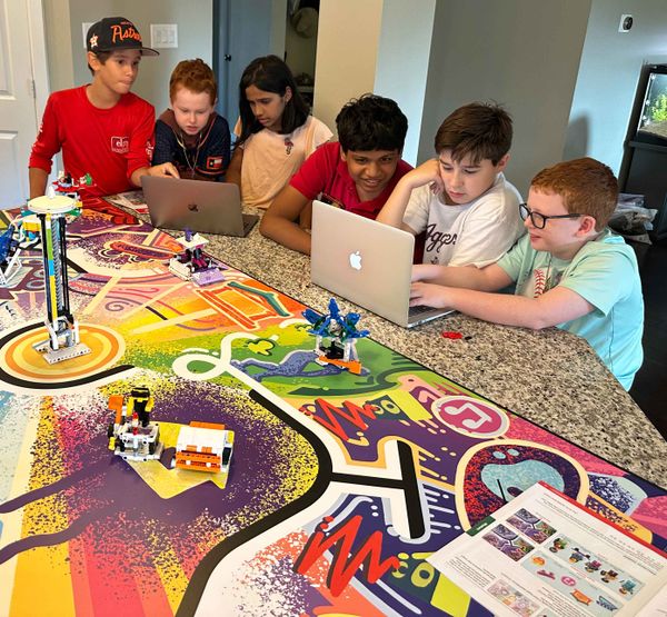 Members of FIRST LEGO League club work to program their robot.
