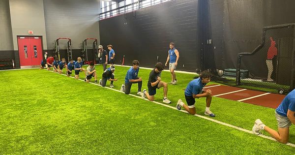 Athletes from the Tomball Kings perform dynamic warmups on indoor turf during off-season training at Texas Sports Medicine Center.
