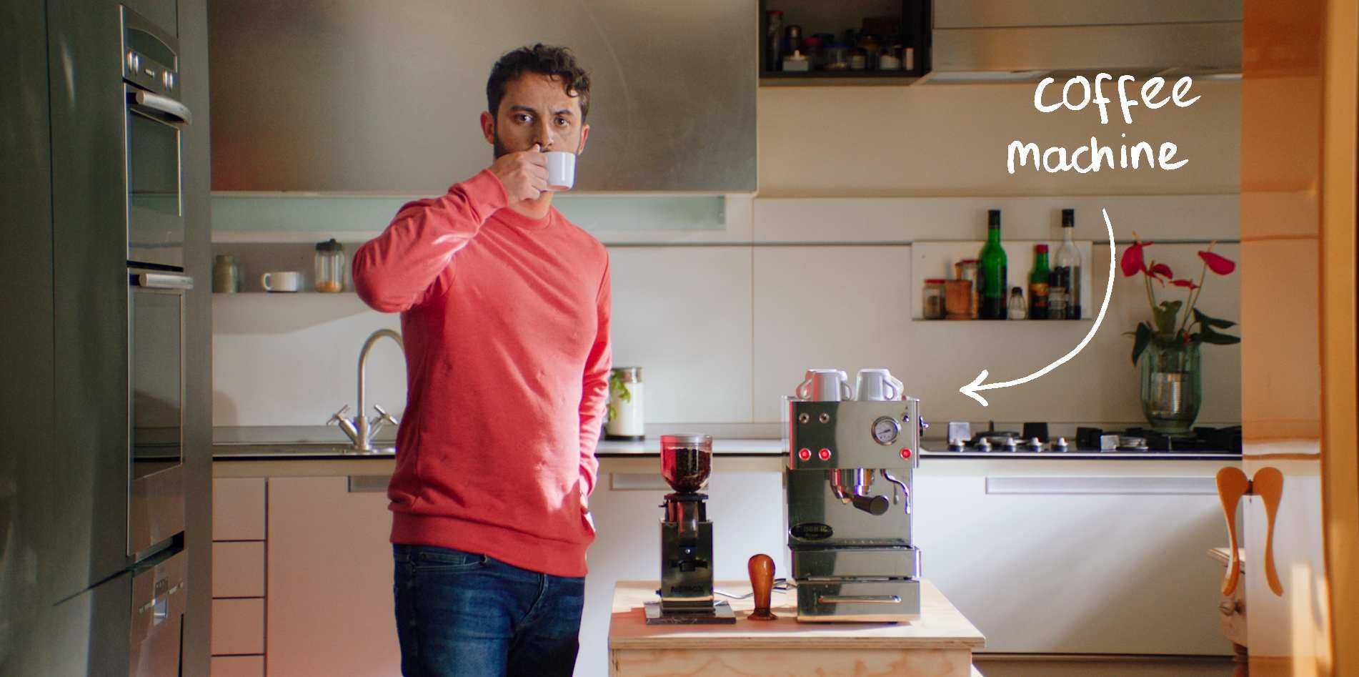 Male-Renter-Drinking-Coffee-from-His-Coffee-Machine