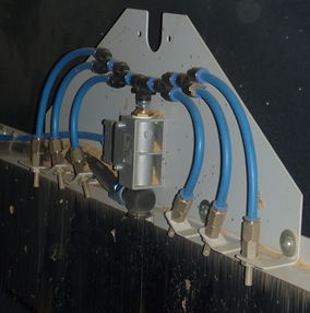 Foto von festinstallierten Blasdüsen in einer Holzbearbeitugnsmaschine. 