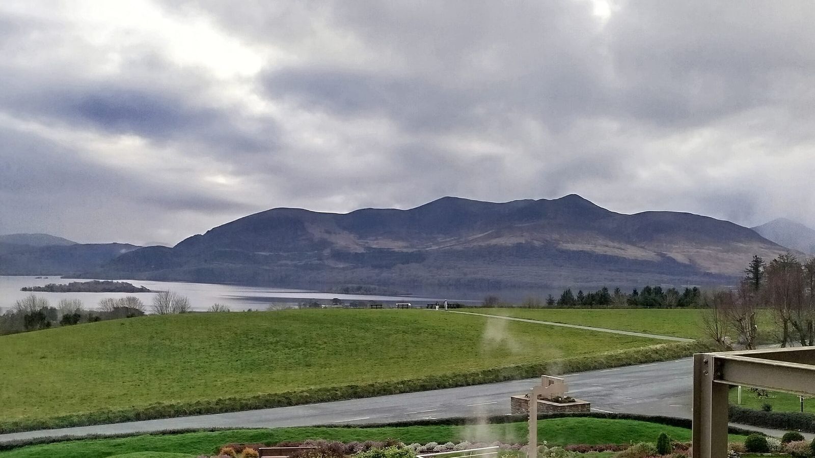 Cloud over the mountains and Lough Leane, seen from a balcony at Aghadoe Heights above Killarney, steam drifting past