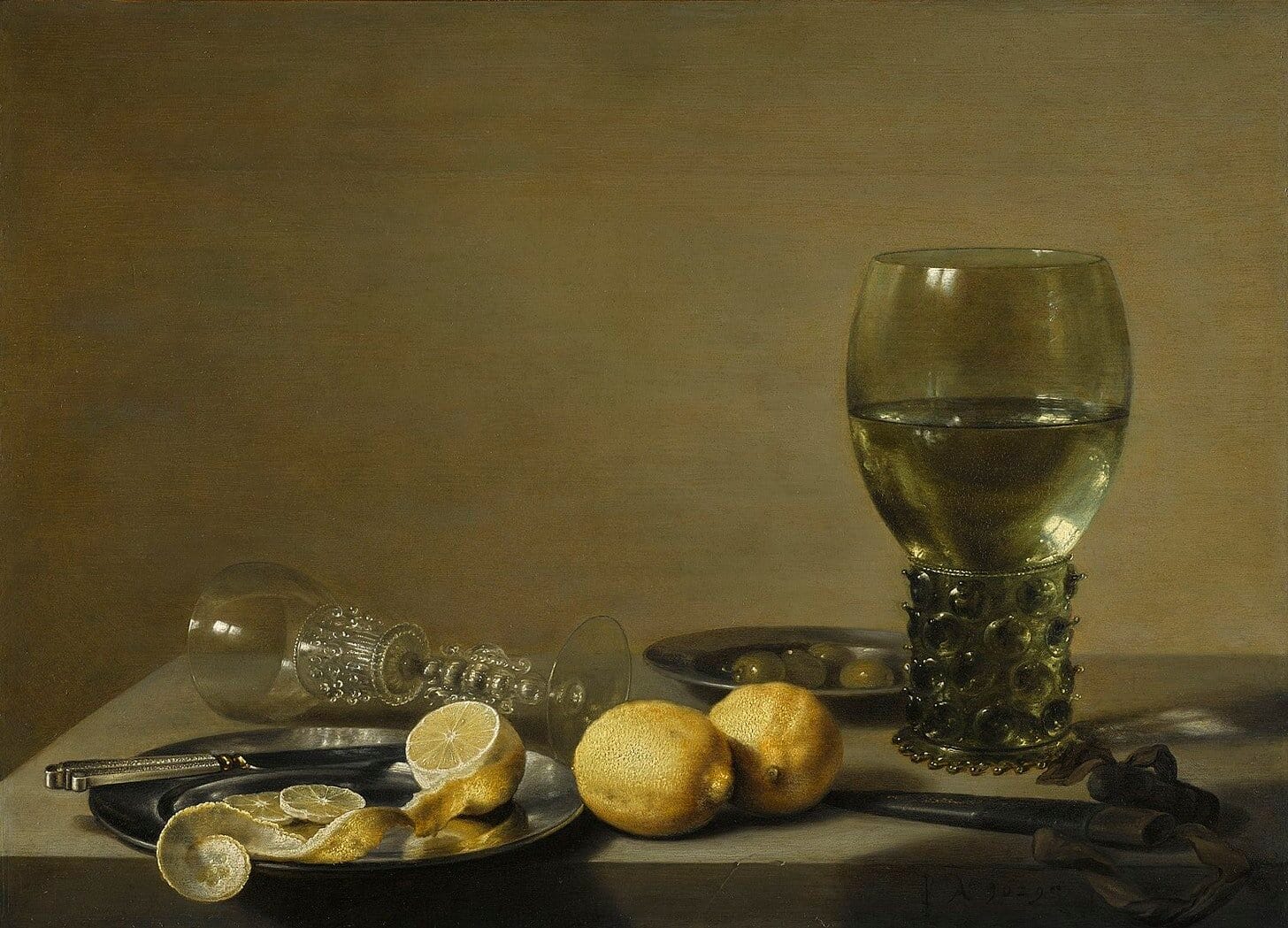 Pieter Claesz, Still Life with Two Lemons, a Facon de Venise Glass, Roemer, Knife and Olives on a Table, 1629. The peeled lemon has its pith showing.
