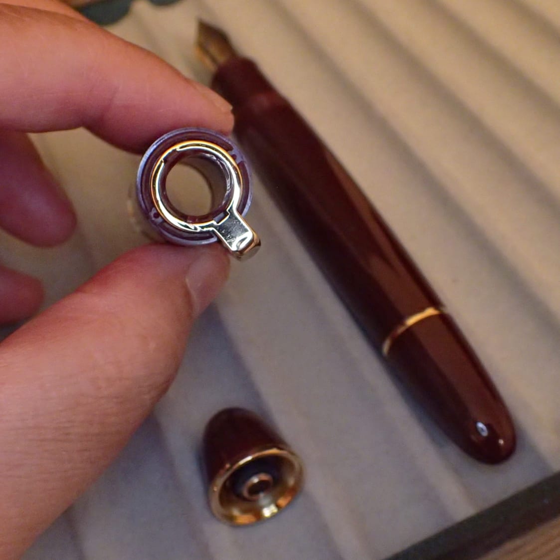 View of the top of the broken cap, showing it is completely open, without the top finial, rendering the cap useless