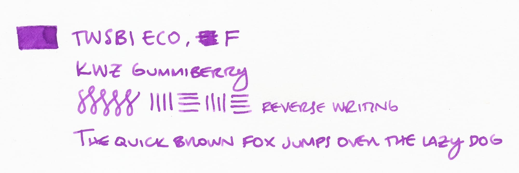 Writing sample using the violet ink: "TWSBI ECO, F; KWZ Gummiberry; test figure-8s and vertical and horizontal lines, reverse writing written by flipping the nib upside-down; The quick brown fox jumps over the lazy dog"