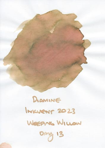 Fountain pen ink swatch of a yellow-green translucent ink with clear pink/peach shading