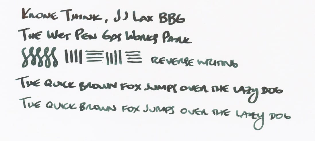 Writing sample in dark blue-green ink: "Krone Think, JJ Lax BBG; The Wet Pen Gas Works Park; figure-8s, vertical and horizontal lines, 'reverse writing' (written using the reverse of the nib); The quick brown fox jumps over the lazy dog (written once with the regular side of the nib, and then with the reverse of the nib, showing different line variations)"