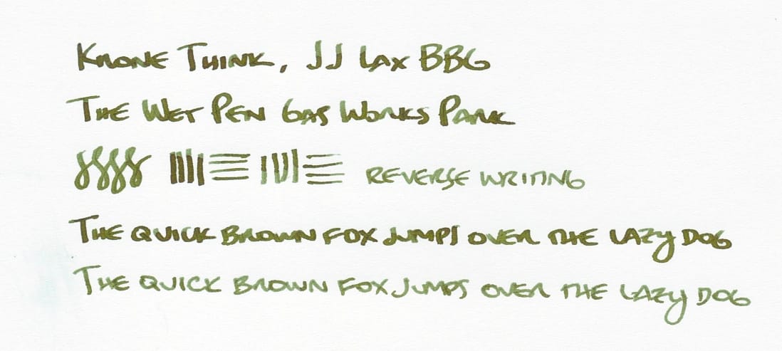 Writing sample in dark brownish-green ink: "Krone Think, JJ Lax BBG; The Wet Pen Gas Works Park; figure-8s, vertical and horizontal lines, 'reverse writing' (written using the reverse of the nib); The quick brown fox jumps over the lazy dog (written once with the regular side of the nib, and then with the reverse of the nib, showing different line variations)"