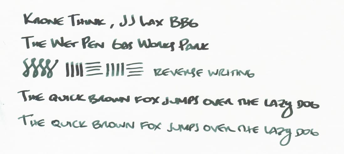 Writing sample in dark blue-green ink: "Krone Think, JJ Lax BBG; The Wet Pen Gas Works Park; figure-8s, vertical and horizontal lines, 'reverse writing' (written using the reverse of the nib); The quick brown fox jumps over the lazy dog (written once with the regular side of the nib, and then with the reverse of the nib, showing different line variations)"