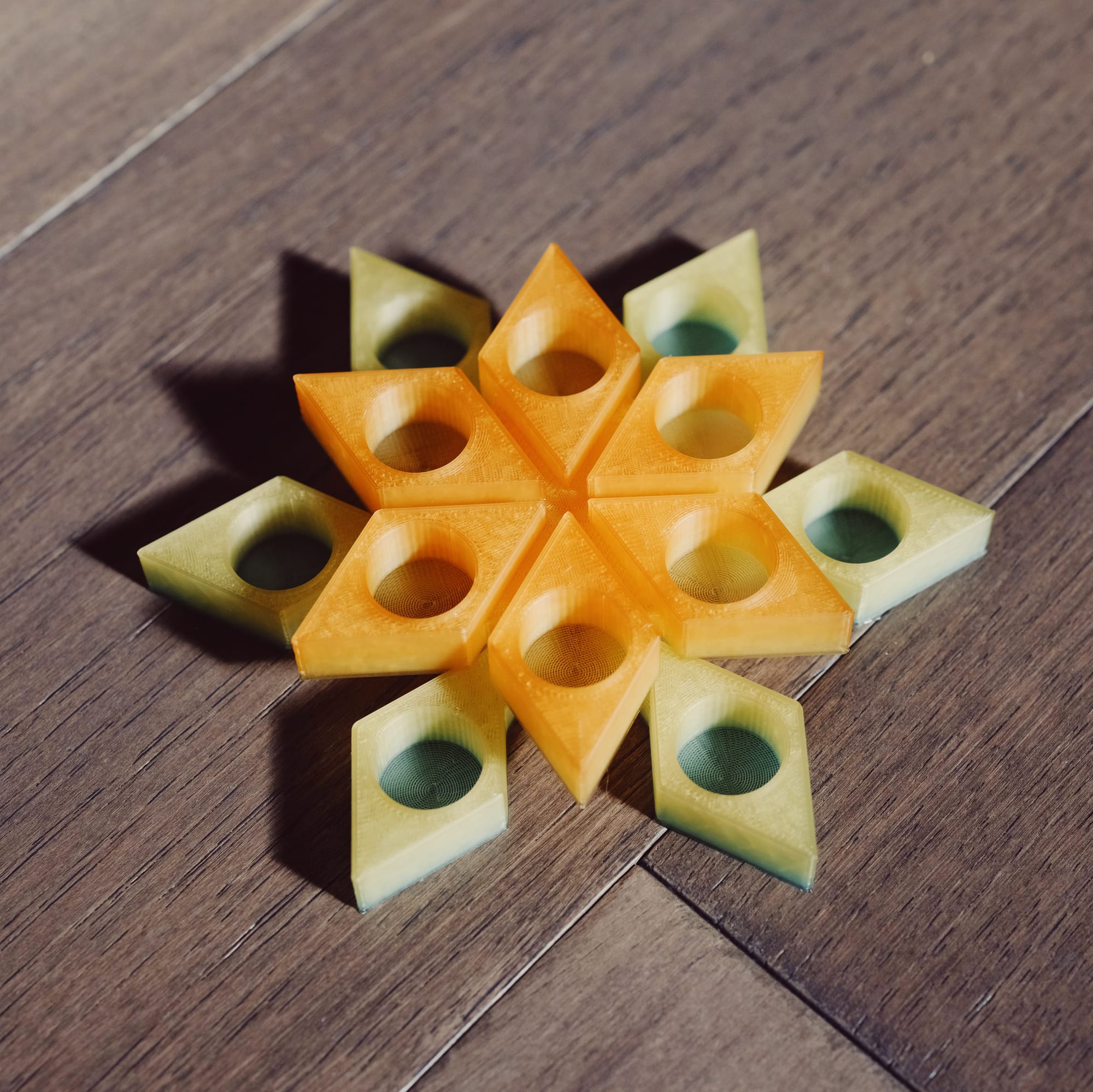 3D-printed, snowflake-shaped stand with holes to hold ink sample vials