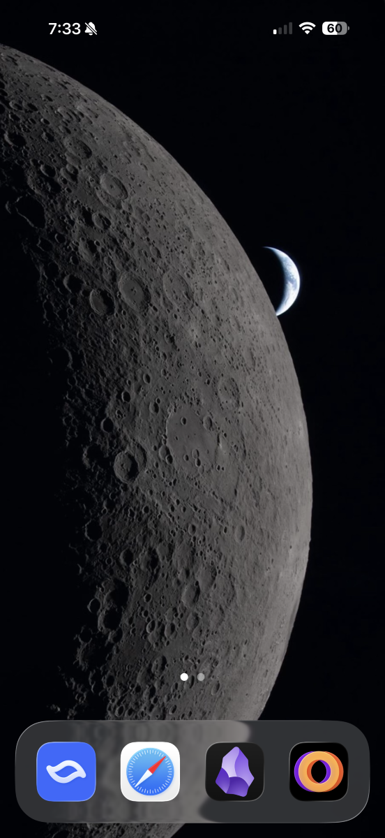 Screenshot of an iPhone homescreen with a wallpaper of the moon with a crescent earth in the background