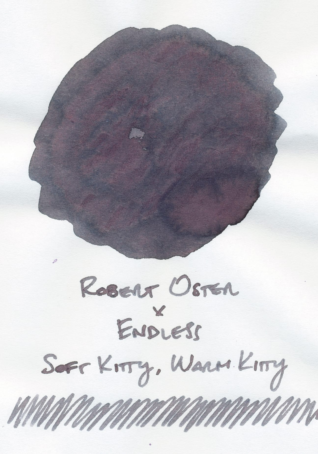 Fountain pen ink swatch of a warm gray ink with pink, purple, and blue undertones/shading