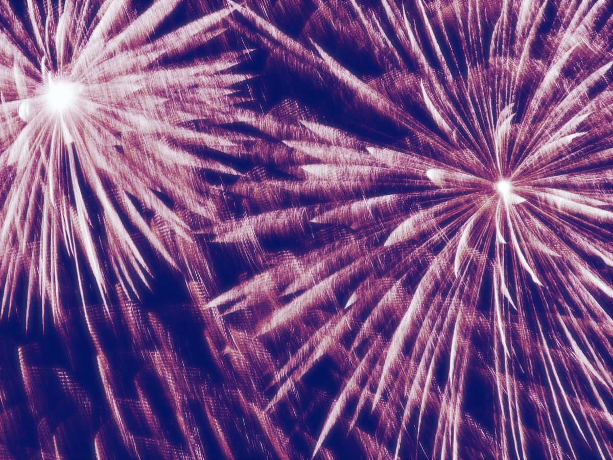 Golden, wispy fireworks filling the frame, with a slight bluish contrasting overlay