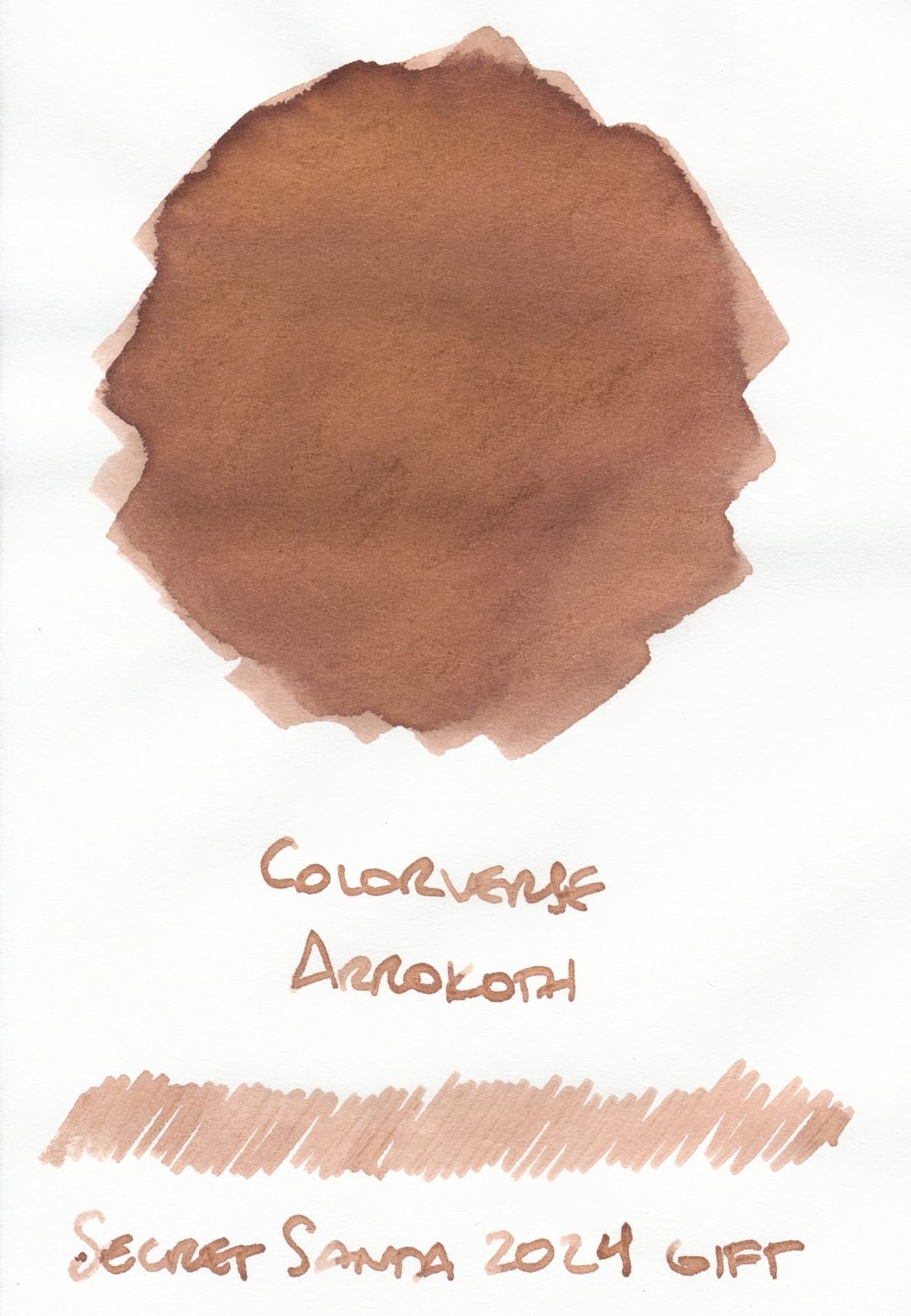 Fountain pen ink swatch of a medium-light, chocolaty brown ink labeled "Colorverse Arrokoth; Secret Santa 2024 gift"