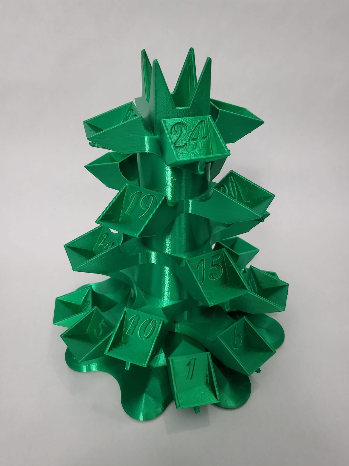 A green, 3D-printed, Christmas-tree shaped stand to hold Diamine Inkvent ink bottles with numbers to correspond with each day's ink
