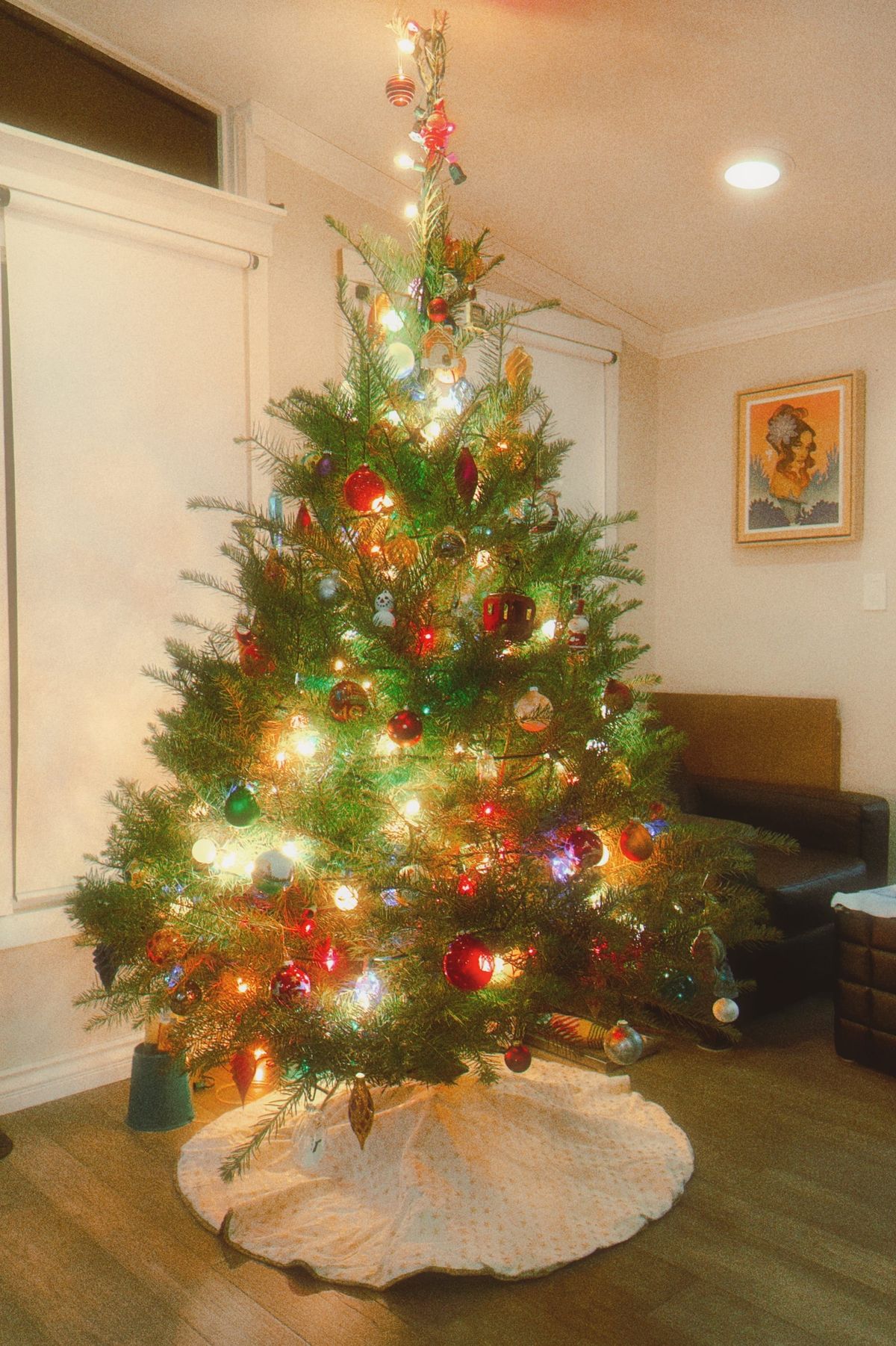 Dreamy, vintage-style image of a lit and decorated Christmas tree