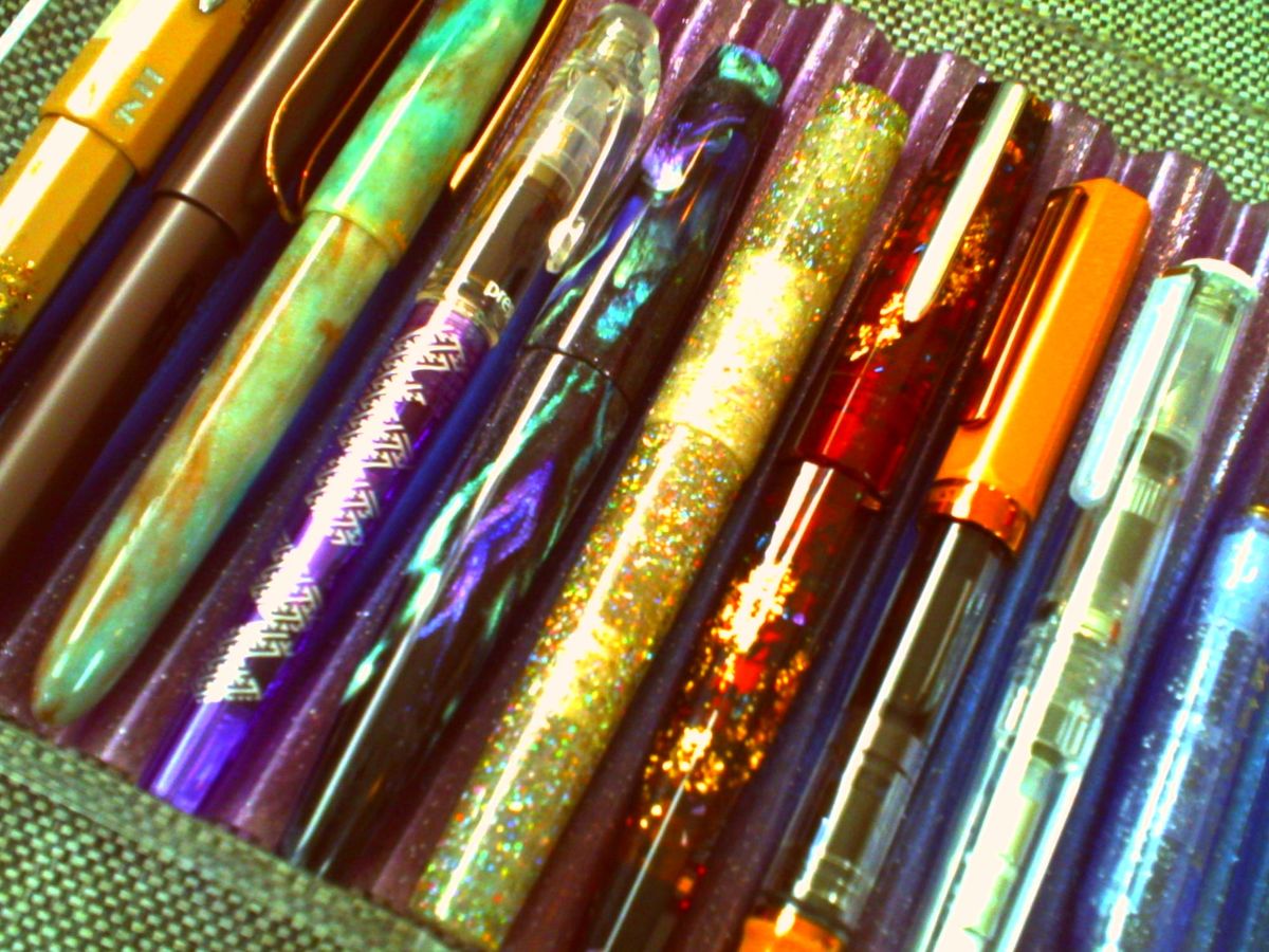 Low-res, overexposed, off-kilter picture of a tray of different fountain pens