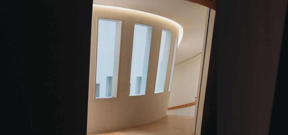 A bright spiral corridor, viewed from inside a dark doorway