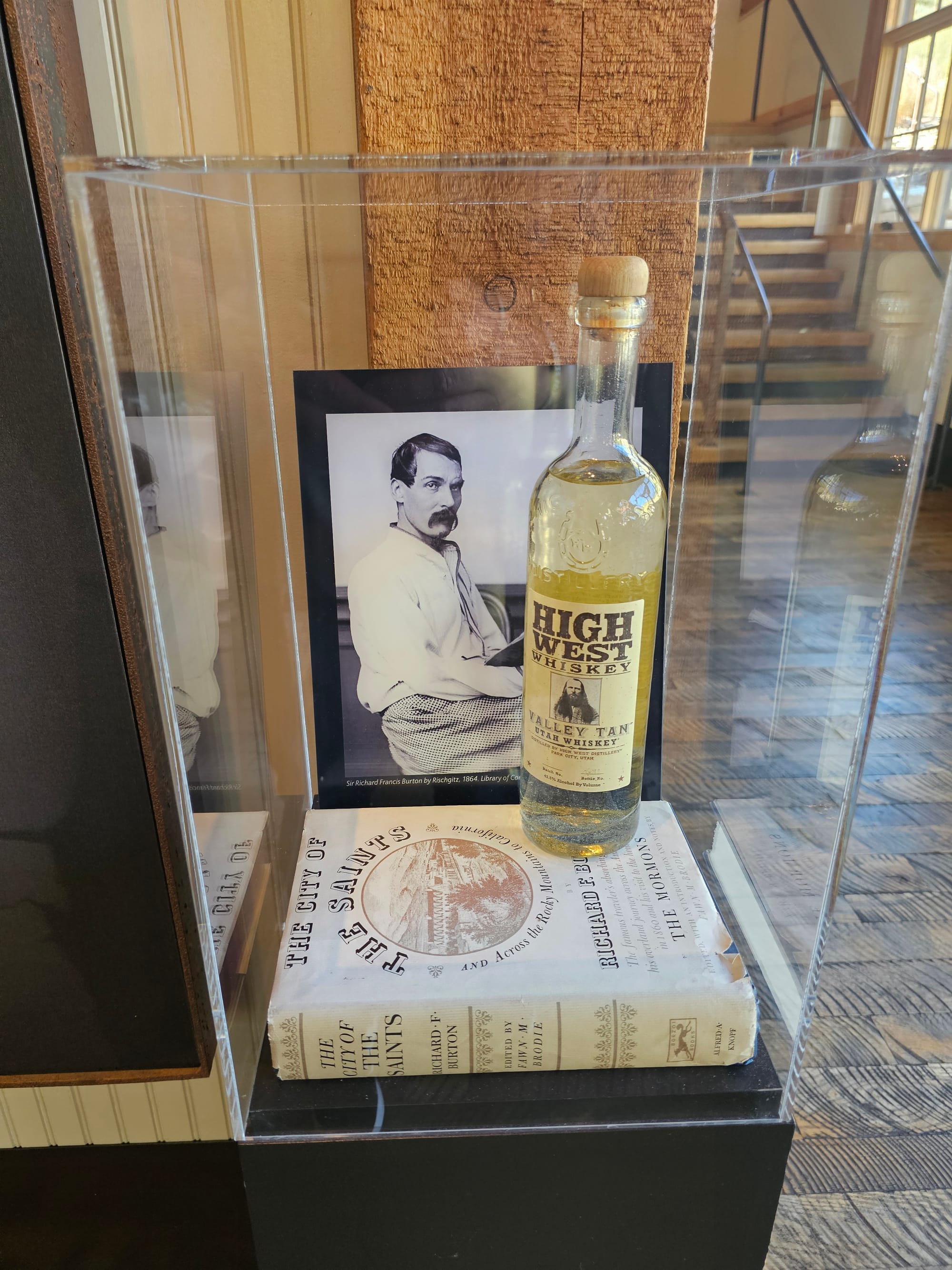 Valley Tan bottle displayed beside a historical portrait at High West
