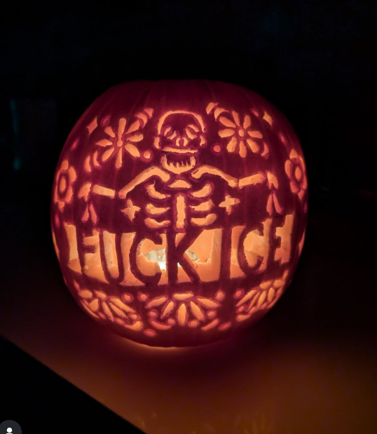  a carved pumpkin with FUCK ICE 