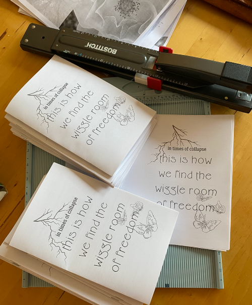 a photo of a stack of black and white zines