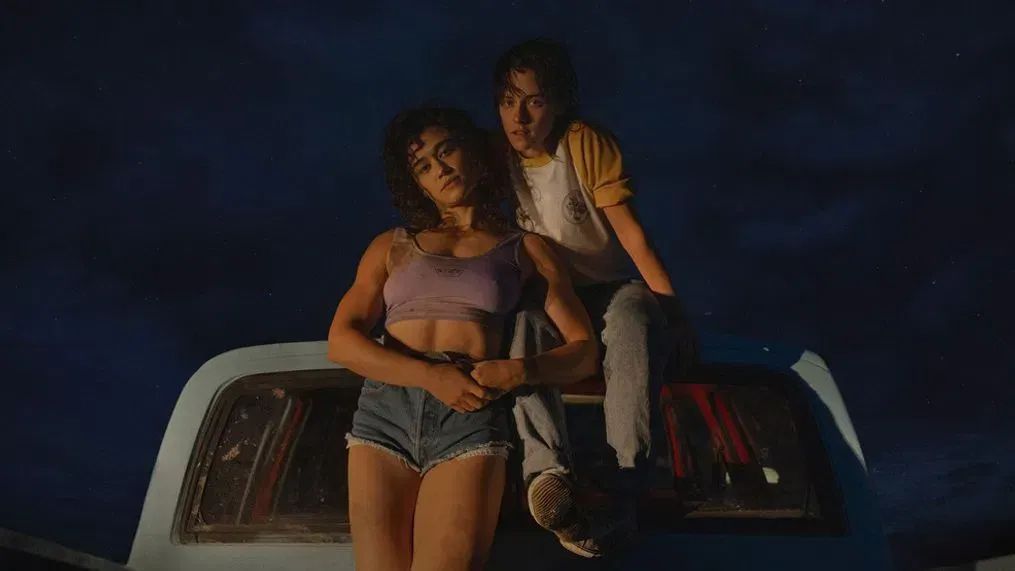 Kristen Stewart and Katy O'Brien posing on the truck they spend much of Love Lies Bleeding driving around