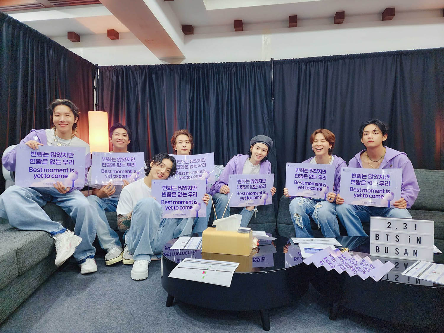 BTS hold up "Best moment is yet to come" signs