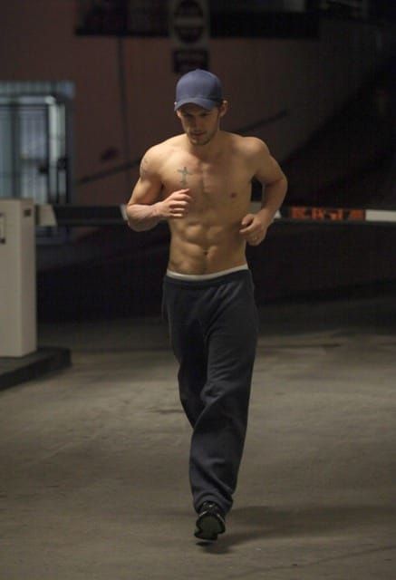 Shirtless sipping water