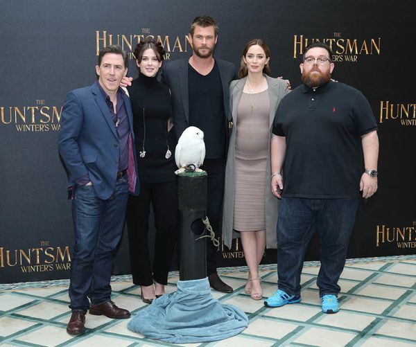 Huntsman people stand next to magnificent owl