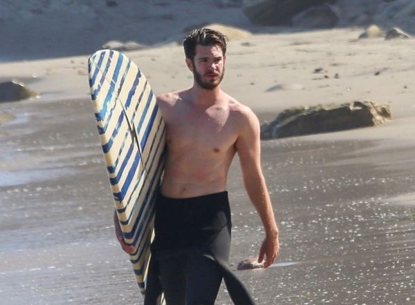 Andrew Garfield surfs on break