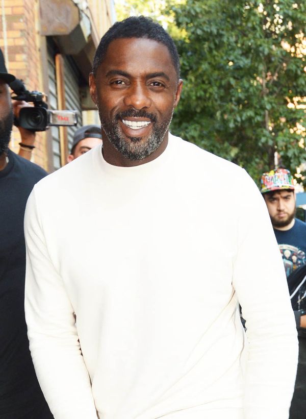 Idris in a white sweater
