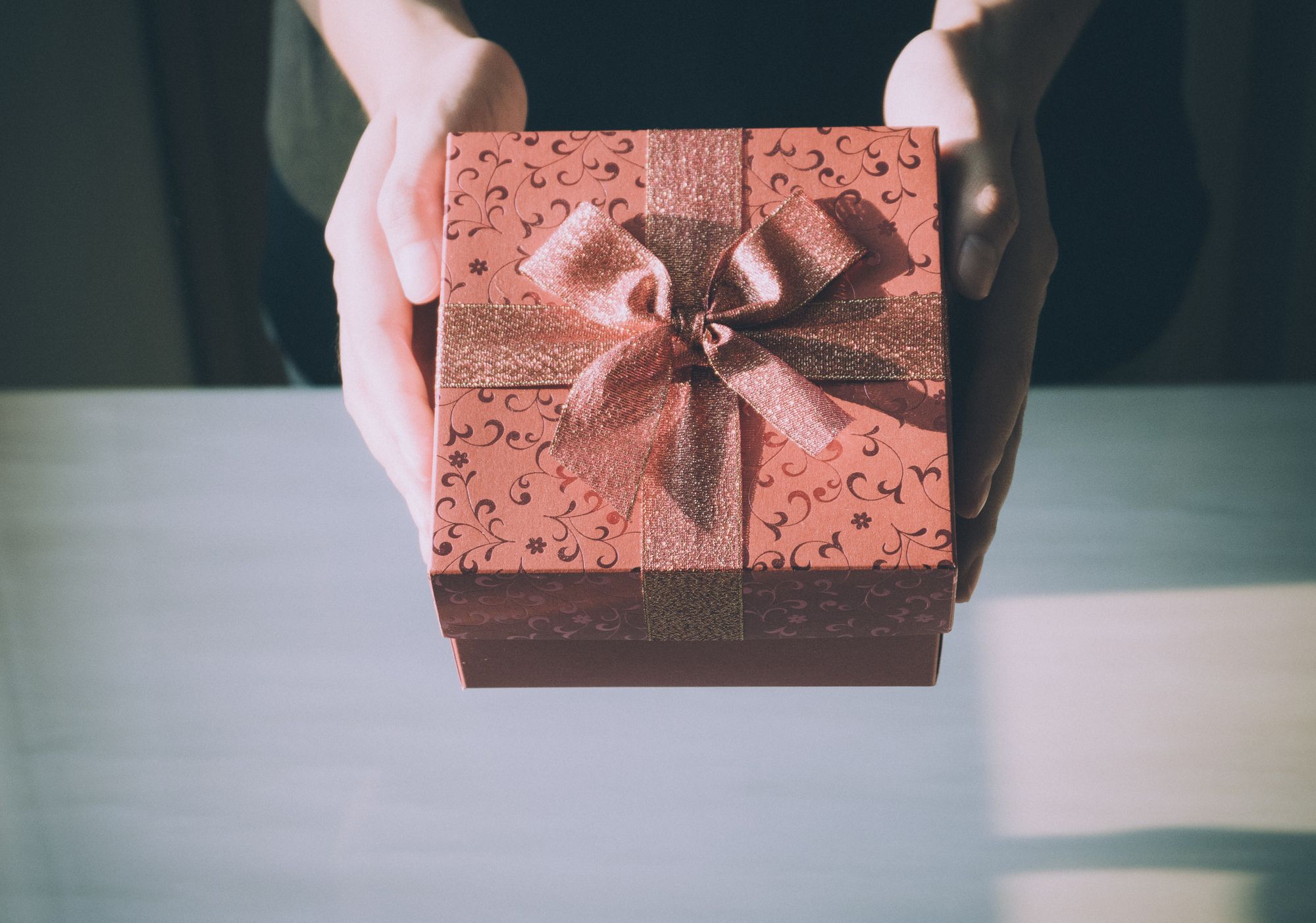 a person holding a wrapped gift