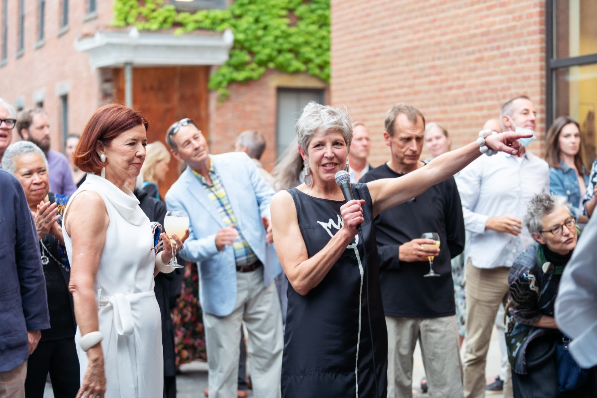 Hudson Hall Board President Susan Hendrick watches as Tambra Dillon, Hudson Hall executive director addresses&nbsp;the guests.