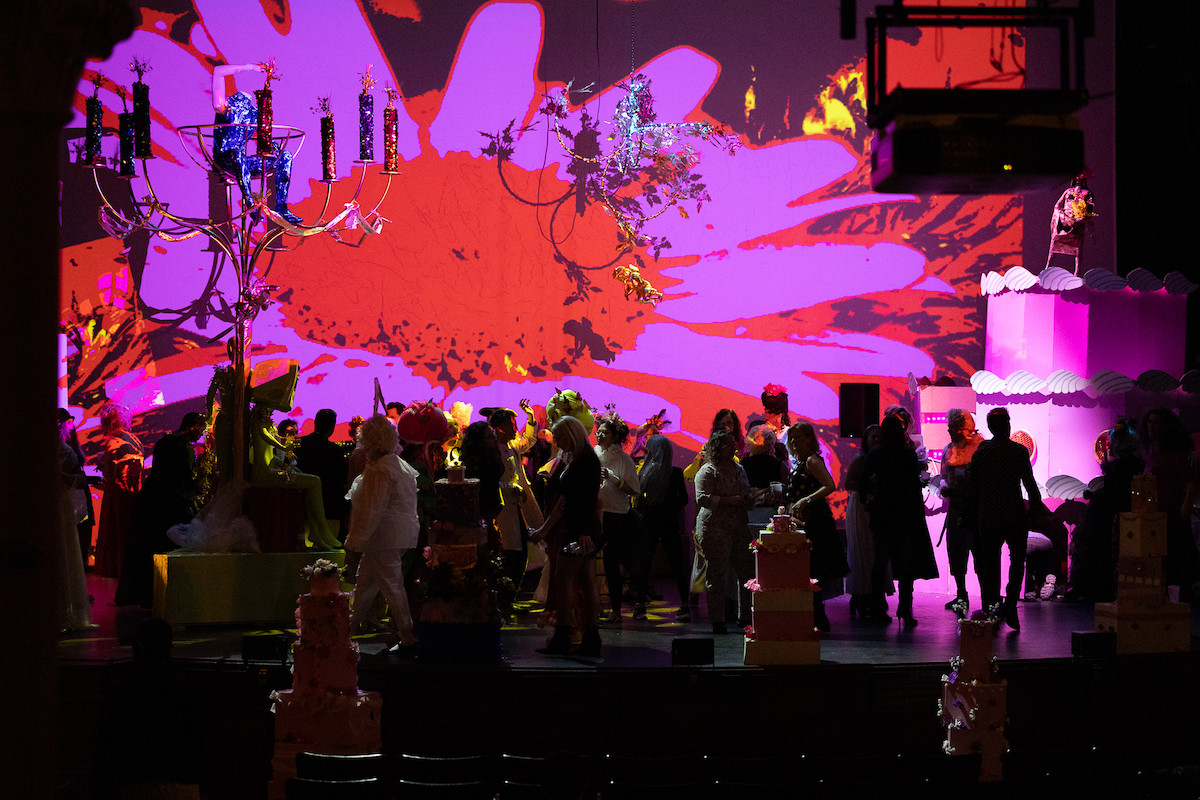 Partygoers dance on stage to the tunes of DJ BFG under light projections by Joe Wheaton.