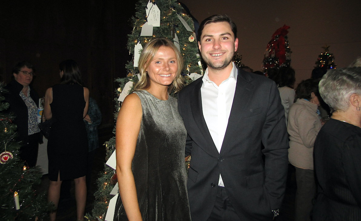 Isabelle Charbonnier and Alex Bennett pose in front of the tree sponsored by Pearson Wallace Insurance.