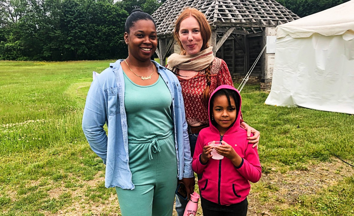 Calisha Croney and her daughter Sophia, with Claire Coffey, who is receiving citizenship assistance from BIC