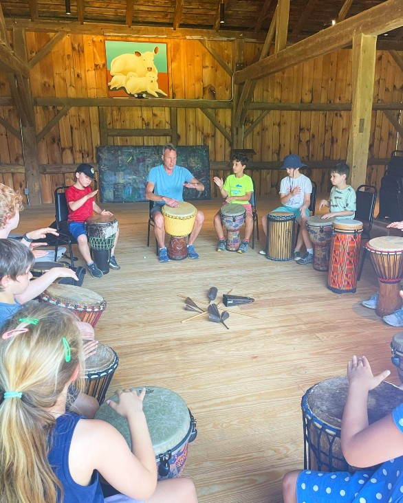 At Flying Cloud's S-M-Art summer&nbsp;camp at April Hill in Egremont. The youth are drumming&nbsp;with musician Rick Strum on his collection of African drums. Photo credit: Maria Rundle