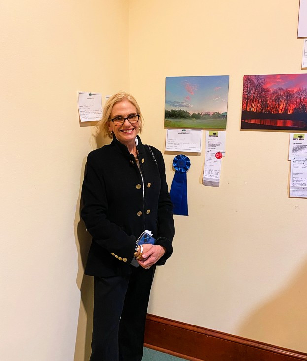 Emma Sweeney Lewis, president of the Millbrook Garden Club, in front her photo, which won the Garden Club of America Novice Award. Photo:&nbsp;Tom Kopfensteiner