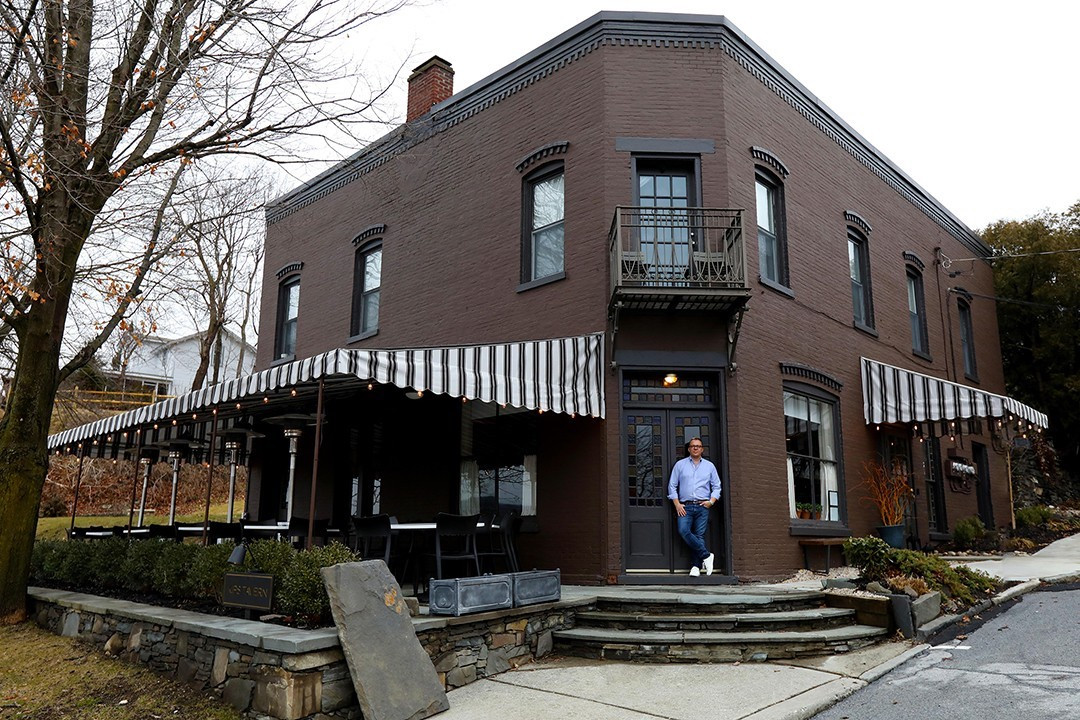 Owner Christopher Dorsey in front of Kip's Tavern, which has a 28-seat patio overlooking the Hudson River.