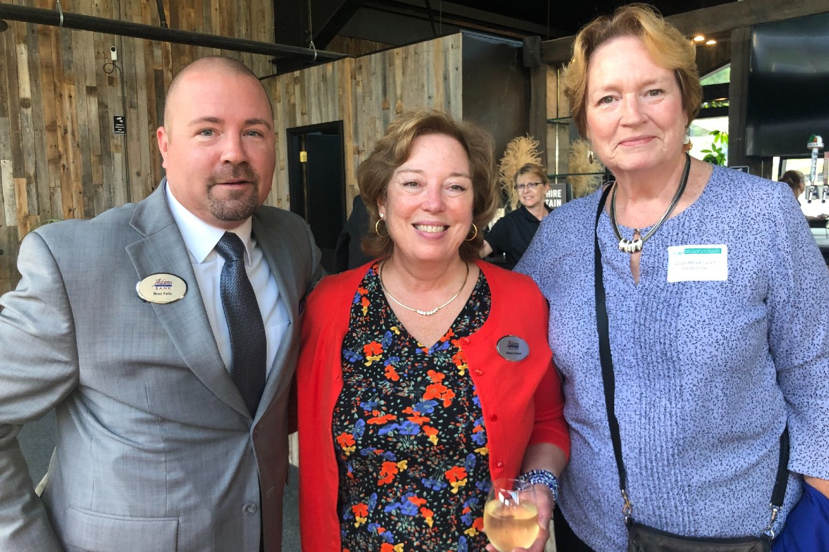 Brad Felix and Elena Tucker of Adams Community Bank, and Susan Moyle Lynch, a Ventfort Hall board member