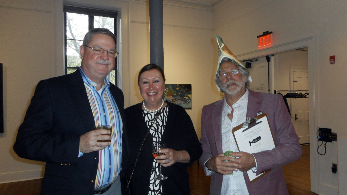 Jack Higbee and Mary Ellen Higbee with Len Grossman, a Hudson Hall volunteer sporting&nbsp;a headpiece inspired by the event's theme.