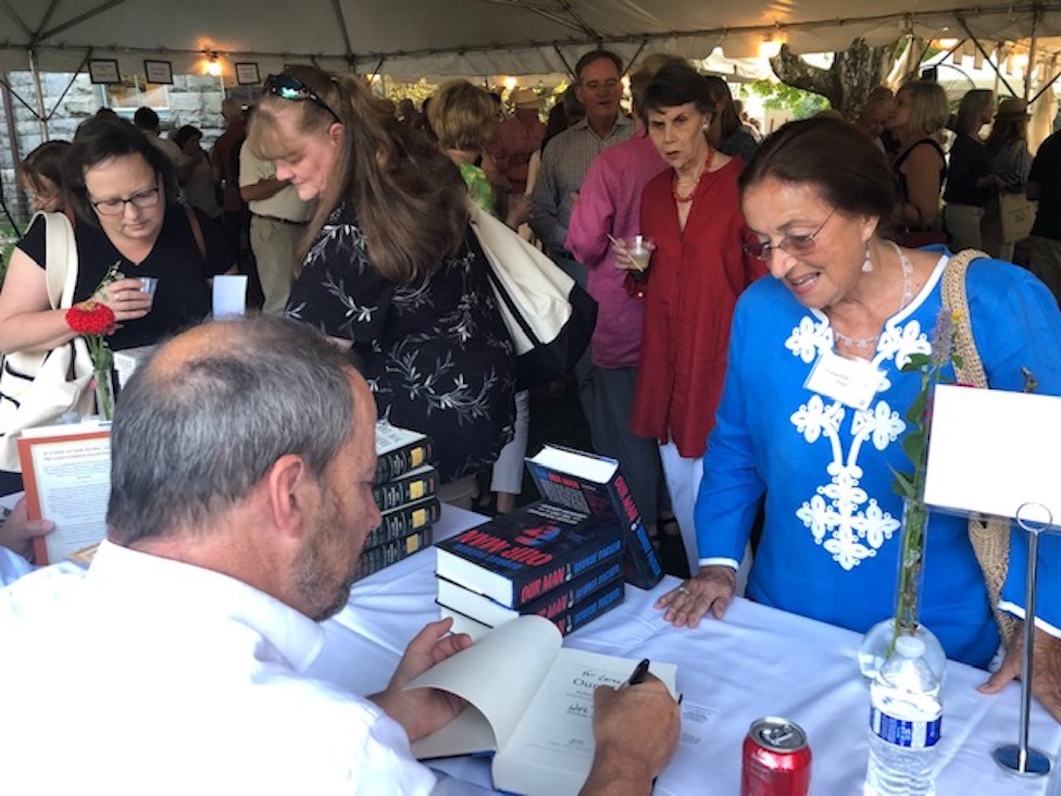 Author George Packer signs a book for board member Lorna Edmundson.&nbsp;All photos by&nbsp;Gretchen Hachmeister.&nbsp;